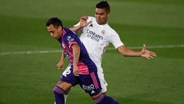 Real Madrid's Brazilian midfielder Casemiro (R) challenges Valladolid's Chilean midfielder Fabian Orellana during the Spanish league football match Real Madrid CF against Real Valladolid FC at the Alfredo di Stefano stadium in Valdebebas, on the