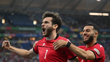 Georgia's forward #07 Khvicha Kvaratskhelia celebrates scoring his team's first goal with Georgia's forward #22 Georges Mikautadze during the UEFA Euro 2024 Group F football match between Georgia and Portugal at the Arena AufSchalke in Gelsenkirchen on June 26, 2024. (Photo by OZAN KOSE / AFP)
