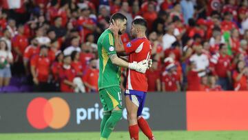 ORLANDO, FLORIDA - JUNE 29: Mauricio Isla of Chile comforts teammates Gabriel Arias after team's elimination of the tournament the CONMEBOL
