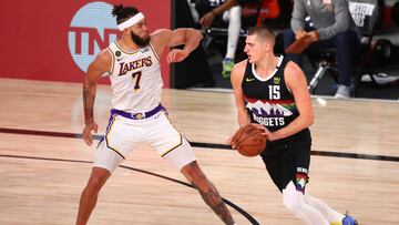 Sep 22, 2020; Lake Buena Vista, Florida, USA; Denver Nuggets center Nikola Jokic (15) dribbles the ball against Los Angeles Lakers center JaVale McGee (7) during the first half of game three of the Western Conference Finals of the 2020 NBA Playoffs at AdventHealth Arena. Mandatory Credit: Kim Klement-USA TODAY Sports