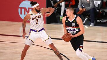 Sep 22, 2020; Lake Buena Vista, Florida, USA; Denver Nuggets center Nikola Jokic (15) dribbles the ball against Los Angeles Lakers center JaVale McGee (7) during the first half of game three of the Western Conference Finals of the 2020 NBA Playoffs at AdventHealth Arena. Mandatory Credit: Kim Klement-USA TODAY Sports