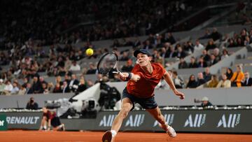 Italy's Jannik Sinner plays a backhand return to France's Richard Gasquet during their men's singles match on Court Philippe-Chatrier on day four of the French Open tennis tournament at the Roland Garros Complex in Paris on May 29, 2024. (Photo by Dimitar DILKOFF / AFP)