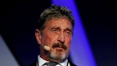 Why was John McAfee in exile and what was he being extradited for?