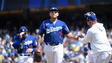 LOS ANGELES, CA - APRIL 16: Starting pitcher Julio Urias #7 of the Los Angeles Dodgers gives the baseball to manager Dave Roberts #30 as he is replaced after giving up two one-run home runs to the Chicago Cubs during the sixth inning at Dodger Stadium on April 16, 2023 in Los Angeles, California.   Kevork Djansezian/Getty Images/AFP (Photo by KEVORK DJANSEZIAN / GETTY IMAGES NORTH AMERICA / Getty Images via AFP)