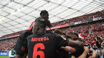 Bayer Leverkusen's German midfielder #10 Florian Wirtz (hidden) celebrates scoring the 3-0 goal with his team-mates and fans during the German first division Bundesliga football match Bayer 04 Leverkusen v Werder Bremen in Leverkusen, western Germany, on April 14, 2024. (Photo by INA FASSBENDER / AFP) / DFL REGULATIONS PROHIBIT ANY USE OF PHOTOGRAPHS AS IMAGE SEQUENCES AND/OR QUASI-VIDEO