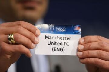 El embajador de la final en Lisboa, el ex internacional portugués Luis Figo sostiene la tarjeta con el nombre del club de fútbol Manchester United durante el sorteo de los cuartos de final de la Liga de Campeones de la UEFA en la sede de la UEFA en Nyon.