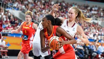 Spain's Astou Ndour (C) and Latvia's Digna Strautmane (R) vie for the ball during Women's Eurobasket 2019 basketball match in Riga, Latvia, on June 30, 2019. (Photo by AFP)
