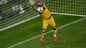 Spanish goalkeeper Iker Casillas (Top) makes a save on a shot by Croatian midfielder Ivan Rakitic (L) during the Euro 2012 football championships match Croatia vs Spain on June 18, 2012 at the Gdansk Arena.    AFP PHOTO/ PATRIK STOLLARZ