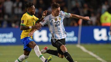 (FILES) In this file photo taken on November 16, 2021, Brazil's Fred (L) and Argentina's Giovani Lo Celso vie for the ball during their South American qualification football match for the FIFA World Cup Qatar 2022 at the San Juan del Bicentenario stadium in San Juan, Argentina. - Gio Lo Celso, a key player in the midfield of Argentina's national football team, will miss the Qatar-2022 World Cup after failing to recover from an injury, local media Ol� and TyC Sports reported on October 8. (Photo by Juan Mabromata / AFP)
