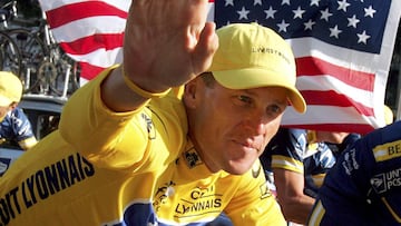 U.S. Postal Service Team rider Lance Armstrong of the United States, the first six-time winner of the Tour de France cycling classic, waves as he cycles past a U.S. flag during the rider&#039;s parade on the Champs-Elysees after the 20th and final stage of the Tour in Paris, in this July 25, 2004 file photo. Armstrong said on August 23, 2012 he would no longer fight doping accusations by the U.S. Anti-Doping agency, a move that appears to put his seven Tour de France titles at risk. REUTERS/Stefano Rellandini/Files (FRANCE - Tags: SPORT CYCLING)