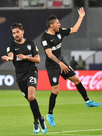 CF Pachuca's Argentinian forward Franco Jara (L) celebrates with his Uruguayan teammate Jonathan Urretaviscaya after scoring a goal during the third place football match of the FIFA Club World Cup UAE 2017 between Al-Jazira and CF Pachuca at the Bin Zayed Stadium in Abu Dhabi on December 16, 2017. 
 / AFP PHOTO / GIUSEPPE CACACE