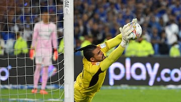 Millonarios' goalkeeper Alvaro Montero stops a penalty kick during the Colombian First Division Football Championship final match between Millonarios and Atletico Nacional at the El Campin stadium in Bogota on June 24, 2023. (Photo by Raul ARBOLEDA / AFP)
