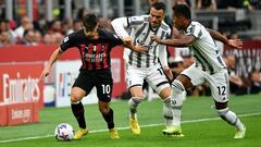 AC Milan's Spanish midfielder Brahim Diaz (L) fights for the ball with Juventus' Serbian midfielder Filip Kostic (C) and Juventus' Brazilian defender Alex Sandro during the Italian Serie A football match between AC Milan and Juventus at the San Siro stadium in Milan on October 8, 2022. (Photo by Isabella BONOTTO / AFP) (Photo by ISABELLA BONOTTO/AFP via Getty Images)