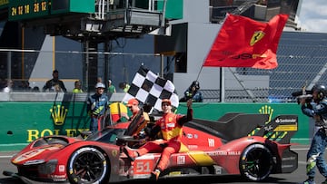 Ferrari N.51 499P Hypercar drivers British James Calado (L) and Italian Antonio Giovinazzi (R) join Italian Alessandro Pier Guidi (car) to celebrate after winning the 24 hours of Le Mans