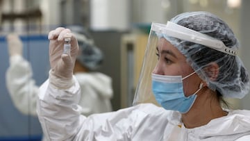 A medical worker poses for a picture while holding a vial with Sputnik V (Gam-COVID-Vac) vaccine against the coronavirus disease (COVID-19) at a mobile vaccination centre in the Palace of the Republic concert hall in Almaty, Kazakhstan April 2, 2021. REUTERS/Pavel Mikheyev