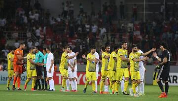 Players greet each other at the end of the AFC Cup football match between Iraq's Al-Zawraa club and Lebanon's Al-Ahed club at the Karbala Sports City stadium on April 10, 2018. The match ended 1-1.