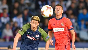 FC Salzburg&#039;s South Korean forward Hwang Hee-Chan (L) vies with Real Sociedad&#039;s Mexican defender Hector Moreno during the UEFA Europa League first leg round of 32 football match between Real Sociedad and FC Salzburg at the Anoeta stadium in San 