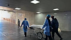 BEIJING, CHINA - JANUARY 02: (CHINA OUT) Hospital workers and a relative wheel a body on a gurney out of the busy emergency room at a hospital on January 2, 2023 in Beijing, China. China has seen a surge in COVID-19 cases since the government lifted its strict zero tolerance measures to contain the virus earlier this month and hospitals in many cities with severe COVID-19 outbreaks have been overwhelmed by the increase in patients. (Photo by Getty Images)