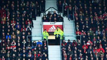 Fans are seen in a small section between main seating blocks during the Premier League match between Manchester United and Arsenal at Old Trafford