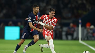 Paris Saint-Germain's Moroccan midfielder #02 Achraf Hakimi (L) and Girona's Spanish defender #03 Miguel Gutierrez (R) fight for the ball during the UEFA Champions League 1st round day 1 football match between Paris Saint-Germain (PSG) and Girona FC at the Parc des Princes Stadium, in Paris, on September 18, 2024. (Photo by FRANCK FIFE / AFP)