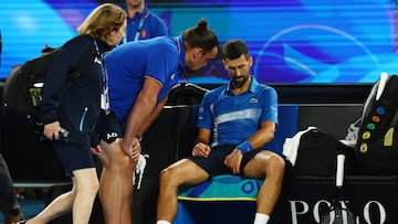 Tennis - Australian Open - Melbourne Park, Melbourne, Australia - January 21, 2025 Serbia's Novak Djokovic receives medical attention after sustaining an injury during his quarter final match against Spain's Carlos Alcaraz REUTERS/Edgar Su