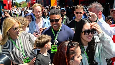 Brazilian football legend Ronaldo Nazario arrives with his wife Celina Locks to attend the 2025 Emilia Romagna Formula One Grand Prix at the Imola autodrome in Imola, on May 18, 2025. (Photo by Andrej ISAKOVIC / AFP)