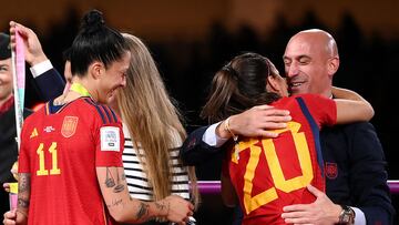 (FILES) Spain's defender #20 Rocio Galvez is congratuled by President of the Royal Spanish Football Federation Luis Rubiales (R) next to Spain's Jennifer Hermoso #10 after winning the Australia and New Zealand 2023 Women's World Cup final football match between Spain and England at Stadium Australia in Sydney on August 20, 2023. Spanish football federation chief Luis Rubiales' apology for kissing star player Jenni Hermoso on the lips after Spain won the Women's World Cup is "insufficient" and his gesture "unacceptable" Spanish Prime Minister said on August 22, 2023. Rubiales, 45, kissed Hermoso as he handed the Spanish team gold medals after they beat England 1-0 in the final in Sydney, provoking outrage in Spain. (Photo by FRANCK FIFE / AFP)