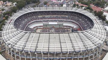FILE - In this June 27, 2018, file photo, supporters of presidential candidate Andres Manuel Lopez Obrador, of the MORENA party, fill Azteca stadium as they wait for him to arrive for his closing campaign rally in Mexico City. The abused hybrid grass of the Azteca Stadium is generating concerns for its poor condition a week before it hosts an NFL regular-season game between the Los Angeles Rams and the Kansas City Chiefs. Last May, stadium authorities changed the surface from natural to hybrid. But the intense activity in the last few months has prevented the grass from reaching an optimum state. (AP Photo/Christian Palma, File)