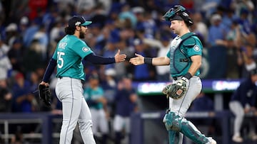 TORONTO, ONTARIO - OCTOBER 12: Cal Raleigh #29 and Andres Mu�oz #75 of the Seattle Mariners celebrate on the field after defeating the Toronto Blue Jays in game one of the American League Championship Series at Rogers Centre on October 12, 2025 in Toronto, Ontario. Cole Burston/Getty Images/AFP (Photo by Cole Burston / GETTY IMAGES NORTH AMERICA / Getty Images via AFP)