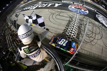 Momento en el que Kyle Busch, cruza la línea de meta con la bandera a cuadros venciendo así en la prueba del NASCAR en Bristol, Tennessee.  