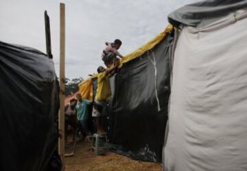Miembros del Movimiento de los Trabajadores Sin Techo de Brasil (MTST) trabajan en la construcción de las chozas en el campamento "La Copa Mundial de los Pueblos", que alberga una estimación de 2.800 familias del movimiento.