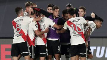 River Plate's defender Gonzalo Montiel (hidden-C) celebrates with teammates after scoring the team's third goal against Colon during their Argentine Professional Football League match at the Monumental stadium in Buenos Aires, on April 11, 2021. (Photo by ALEJANDRO PAGNI / AFP)