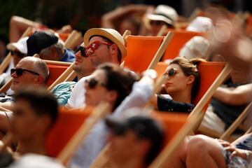Espectadores de la pantalla gigante en el recinto de Roland Garros descansan viendo el tenis.
