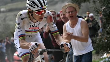 Team UAE's slovenain rider Tadej Pogacar rides as he sustains an injury on his arm after a crash during the 19th one-day classic Strade Bianche (White Roads) men's cycling race between Siena and Siena in Tuscany on March 8, 2025. (Photo by Marco BERTORELLO / AFP)