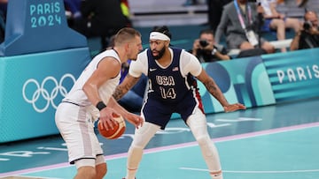 During the men's preliminary round group C basketball match between Serbia and USA at the Pierre-Mauroy stadium in Villeneuve-d'Ascq, northern France, Serbia's #15 Nikola Jokic (left) challenges USA's #14 Anthony Davis. The game took place on July 28, 2024.