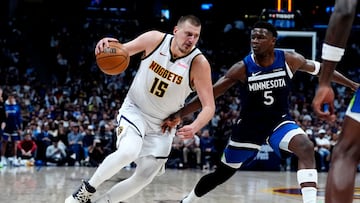 Mar 12, 2025; Denver, Colorado, USA; Minnesota Timberwolves guard Anthony Edwards (5) defends Denver Nuggets center Nikola Jokic (15) in the second half at Ball Arena. Mandatory Credit: Ron Chenoy-Imagn Images