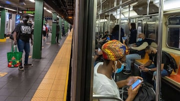 NEW YORK, NY - JUNE 08: People ride the subway at Times Square during rush hour on the first day of phase one of the reopening after the coronavirus lockdown on June 8, 2020 in New York City. New York City enters phase one one hundred days after the first