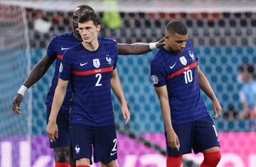 rance's Benjamin Pavard and Kylian Mbappe look dejected after losing the penalty shoot-out.