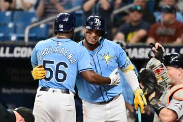 ST PETERSBURG, FLORIDA - APRIL 24: Randy Arozarena #56 of the Tampa Bay Rays hugs Isaac Paredes #17 after hitting a home run in the first inning against the Detroit Tigers at Tropicana Field on April 24, 2024 in St Petersburg, Florida.