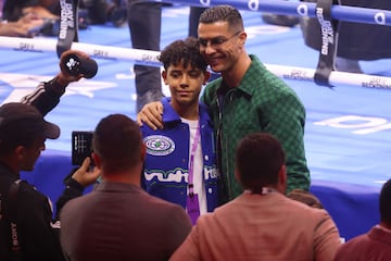 Nassr's Portuguese forward Cristiano Ronaldo poses for a picture with his son ahead of the Day of Reckoning boxing event at the Kingdom Arena in Riyadh on December 23, 2023. 