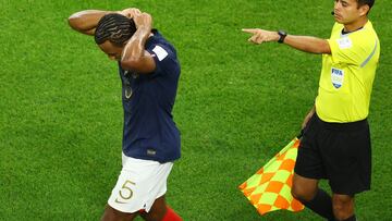 Soccer Football - FIFA World Cup Qatar 2022 - Round of 16 - France v Poland - Al Thumama Stadium, Doha, Qatar - December 4, 2022 France's Jules Kounde removes jewellery REUTERS/Lee Smith