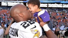 Adrian Peterson de los Minnesota Vikings besa a su hijo.