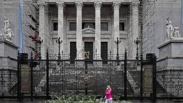 A woman walks past bouquets armed with parsley and other herbs used to induce abortions, placed by activists of Amnesty International, at the doors of the National Congress in Buenos Aires, September 27, 2020 on the eve of the Global Day of Action for Access to Legal and Safe Abortion. (Photo by ALEJANDRO PAGNI / AFP)