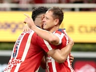 Guadalajara's forward #14 Javier Hernandez (R) celebrates with temamate defender #03 Gilberto Sepulveda after scoring during the Liga MX Apertura football match between Guadalajara and Monterrey at the Akron Stadium in Zapopan, Mexico on November 8, 2025. (Photo by Ulises Ruiz / AFP)