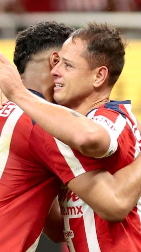 Guadalajara's forward #14 Javier Hernandez (R) celebrates with temamate defender #03 Gilberto Sepulveda after scoring during the Liga MX Apertura football match between Guadalajara and Monterrey at the Akron Stadium in Zapopan, Mexico on November 8, 2025. (Photo by Ulises Ruiz / AFP)
