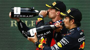 (LtoR) Winner Red Bull Racing's Dutch driver Max Verstappen and third placed Red Bull Racing's Mexican driver Sergio Perez celebrate with champagne on the podium after the Formula One Austrian Grand Prix at the Red Bull race track in Spielberg, Austria on July 2, 2023. (Photo by ERWIN SCHERIAU / APA / AFP) / Austria OUT