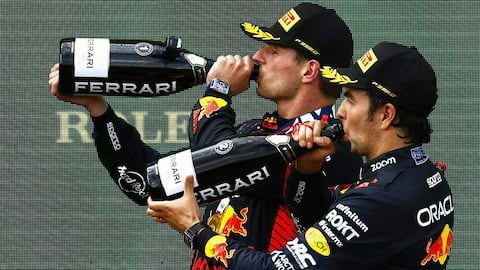 (LtoR) Winner Red Bull Racing's Dutch driver Max Verstappen and third placed Red Bull Racing's Mexican driver Sergio Perez celebrate with champagne on the podium after the Formula One Austrian Grand Prix at the Red Bull race track in Spielberg, Austria on July 2, 2023. (Photo by ERWIN SCHERIAU / APA / AFP) / Austria OUT