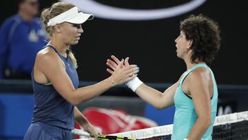 Denmark&#039;s Caroline Wozniacki, left, shakes hands with Spain&#039;s Carla Suarez Navarro after Wozniacki won their quarterfinal at the Australian Open tennis championships in Melbourne, Australia, Wednesday, Jan. 24, 2018. (AP Photo/Vincent Thian)