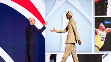 NEW YORK, NEW YORK - JUNE 26: Alex Sarr (R) shakes hands with NBA commissioner Adam Silver (L) after being drafted second overall by the Washington Wizards during the first round of the 2024 NBA Draft at Barclays Center on June 26, 2024 in the Brooklyn borough of New York City. NOTE TO USER: User expressly acknowledges and agrees that, by downloading and or using this photograph, User is consenting to the terms and conditions of the Getty Images License Agreement. Sarah Stier/Getty Images/AFP (Photo by Sarah Stier / GETTY IMAGES NORTH AMERICA / Getty Images via AFP)