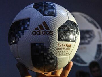 A participant holds the official match ball for the 2018 World Cup football tournament, named "Telstar 18", during its unveiling ceremony in Moscow on November 9, 2017.